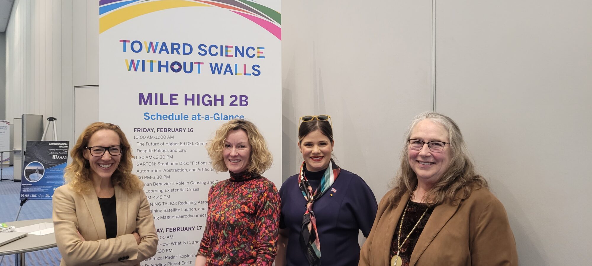 4 women standing in front of a banner that reads Towards science without walls.