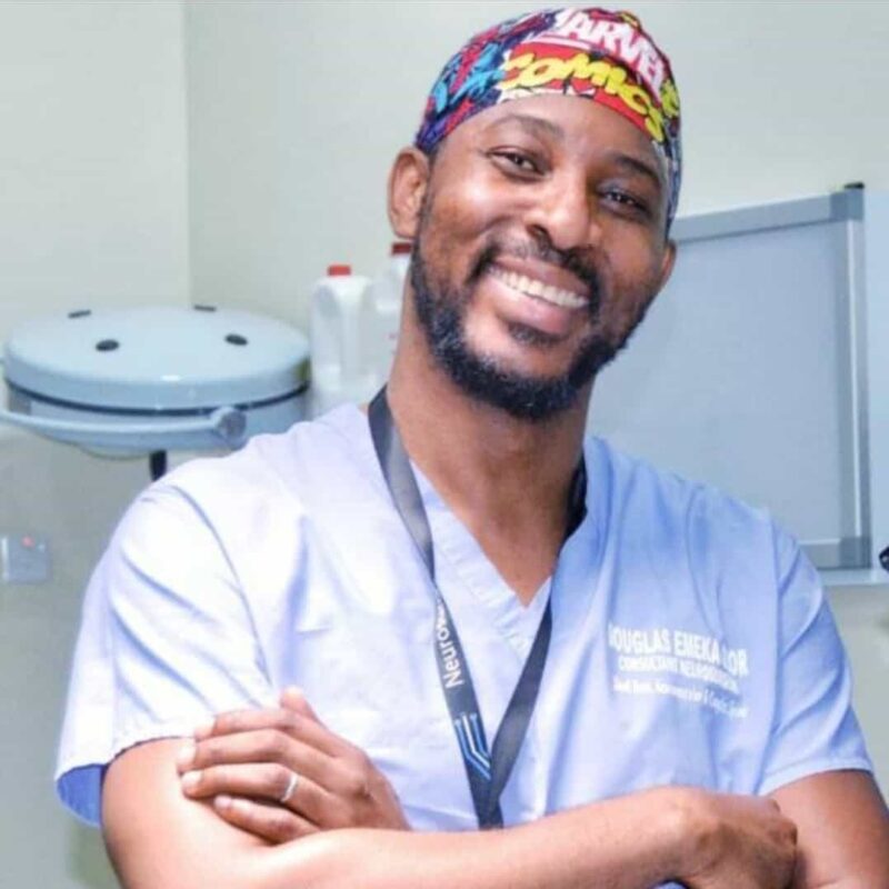 Photo of a man smiling, wearing a medical apron